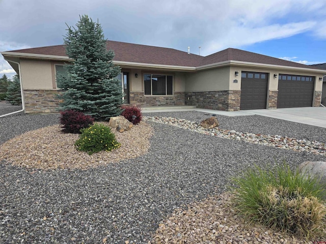 1285 Peppertree Dr, Montrose, CO 81401 - view of front of home with stucco siding, stone siding, an attached garage, and concrete driveway