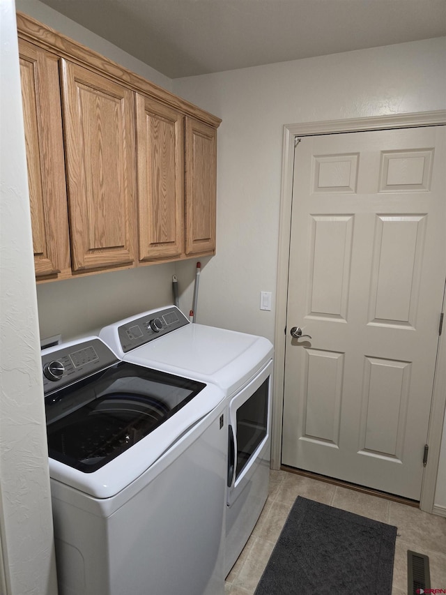 1285 Peppertree Dr, Montrose, CO 81401 - laundry room with washer and dryer, cabinet space, and light tile patterned floors