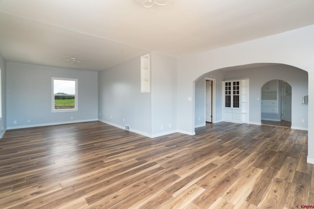 6038 Townsend Rd, Delta, CO 81416 - spare room featuring arched walkways and wood finished floors