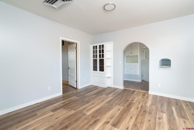 6038 Townsend Rd, Delta, CO 81416 - unfurnished room featuring arched walkways and wood finished floors