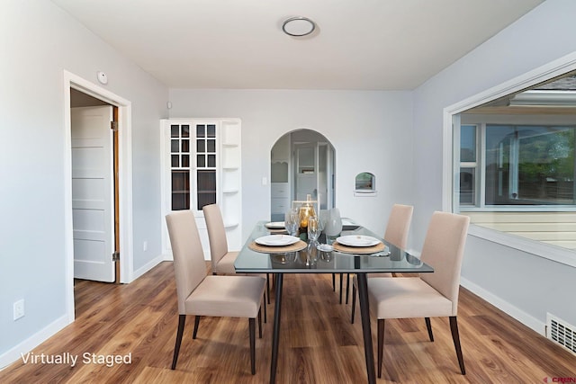 6038 Townsend Rd, Delta, CO 81416 - dining room featuring arched walkways and wood finished floors
