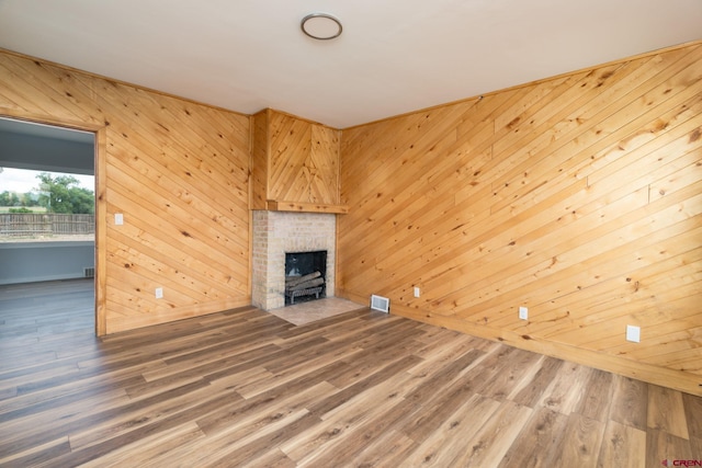 6038 Townsend Rd, Delta, CO 81416 - unfurnished living room with wooden walls, a brick fireplace, and wood finished floors