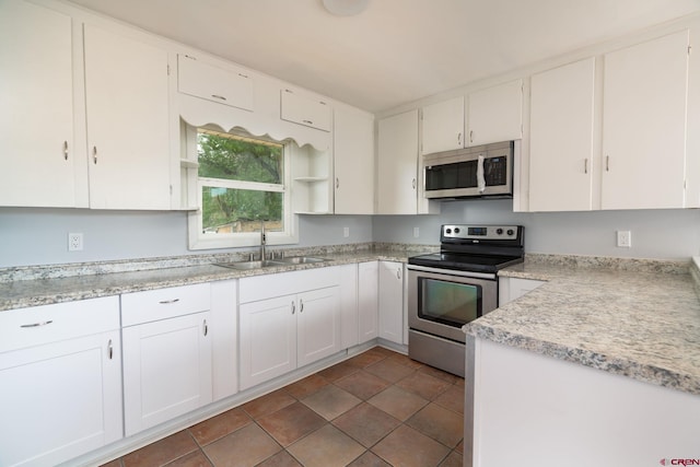 6038 Townsend Rd, Delta, CO 81416 - kitchen featuring appliances with stainless steel finishes, white cabinets, light countertops, and open shelves