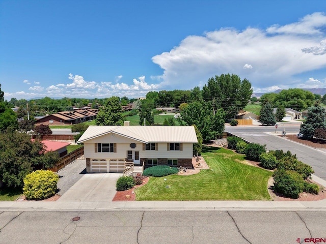 2343 Oldham Way, Montrose, CO 81401 - view of front of house featuring an attached garage, concrete driveway, a front yard, and a metal roof