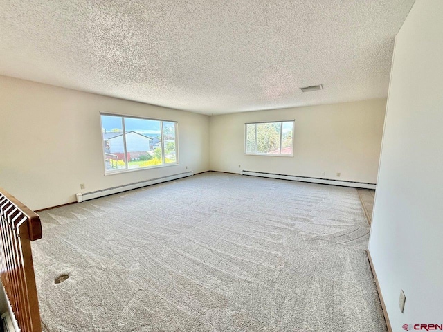 2343 Oldham Way, Montrose, CO 81401 - carpeted empty room featuring a baseboard heating unit and a textured ceiling