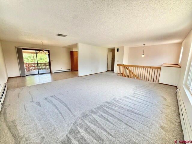 2343 Oldham Way, Montrose, CO 81401 - empty room with a baseboard heating unit, light carpet, baseboard heating, and a textured ceiling