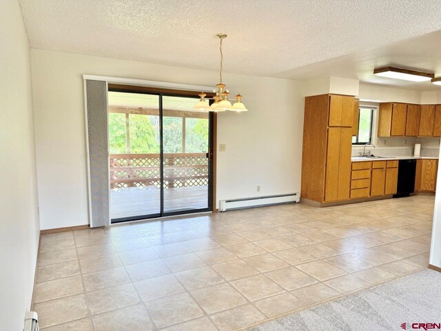 2343 Oldham Way, Montrose, CO 81401 - kitchen featuring baseboard heating, brown cabinets, a chandelier, light countertops, and a textured ceiling