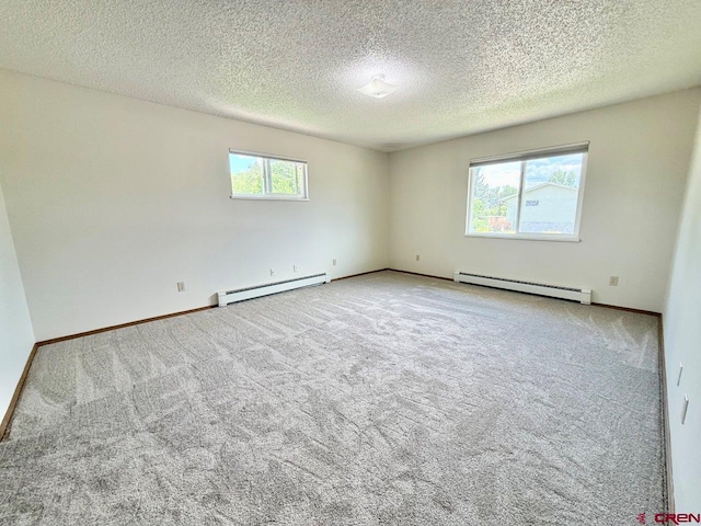 2343 Oldham Way, Montrose, CO 81401 - carpeted spare room featuring baseboard heating and a textured ceiling
