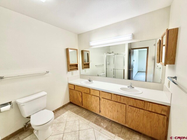 2343 Oldham Way, Montrose, CO 81401 - full bath featuring tile patterned floors, a shower stall, and double vanity