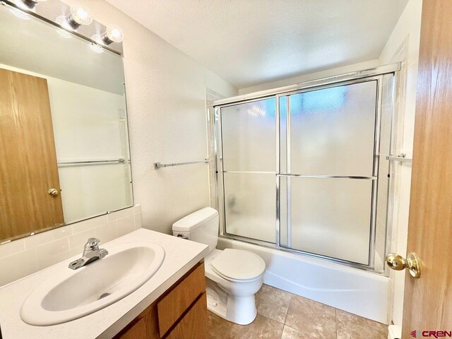 2343 Oldham Way, Montrose, CO 81401 - bathroom with vanity and bath / shower combo with glass door