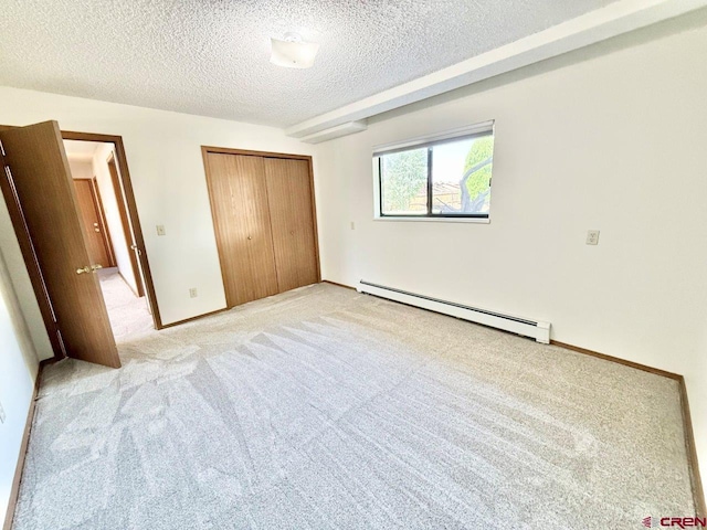 2343 Oldham Way, Montrose, CO 81401 - unfurnished bedroom featuring a baseboard heating unit, light carpet, a textured ceiling, and a closet