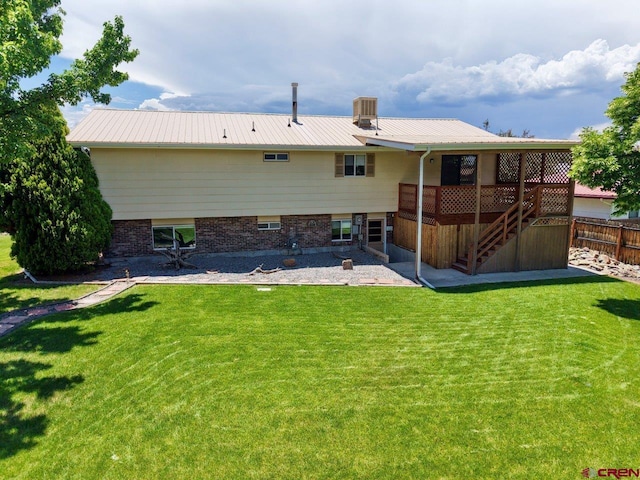 2343 Oldham Way, Montrose, CO 81401 - rear view of house featuring stairway, a wooden deck, and a metal roof