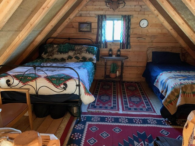 1165 Timber Ridge Rd, Montrose, CO 81401 - bedroom with lofted ceiling and wooden walls