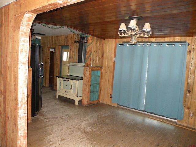 27793 Bb Rd, Nucla, CO 81424 - unfurnished dining area featuring wood walls, hardwood / wood-style flooring, a chandelier, and arched walkways