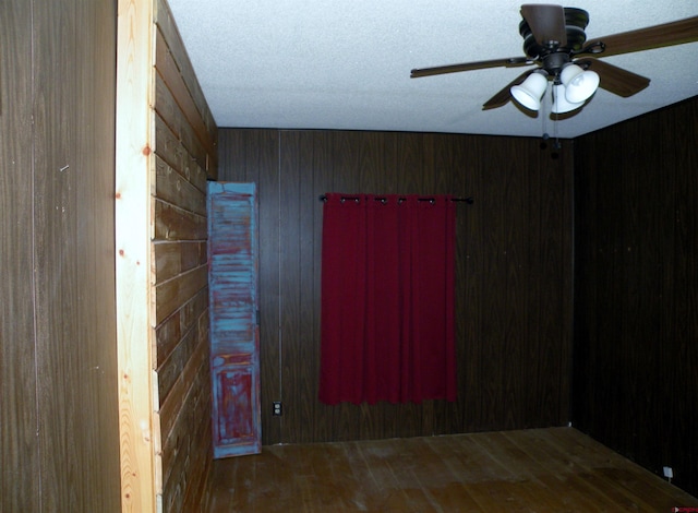 27793 Bb Rd, Nucla, CO 81424 - empty room featuring wood walls, a ceiling fan, and wood finished floors