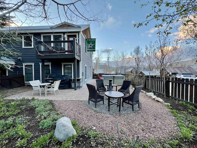 607 Second St Unit B, Crested Butte, CO 81224 - back of house with a hot tub, a balcony, a fenced backyard, and a patio area