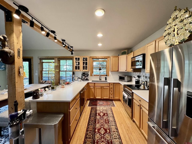 607 Second St Unit B, Crested Butte, CO 81224 - kitchen with appliances with stainless steel finishes, light brown cabinetry, a peninsula, light countertops, and recessed lighting
