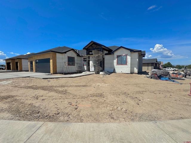 1508 Criterion St, Delta, CO 81416 - view of front of home with an attached garage, concrete driveway, and brick siding