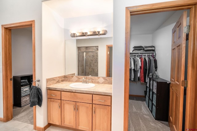 95 Ute Pass W, Durango, CO 81301 - bathroom featuring a stall shower, vanity, and a spacious closet