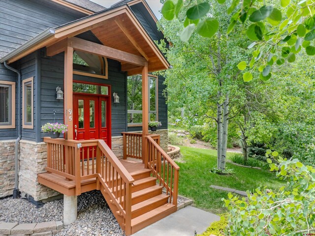 95 Ute Pass W, Durango, CO 81301 - doorway to property with a yard, stone siding, and a shingled roof