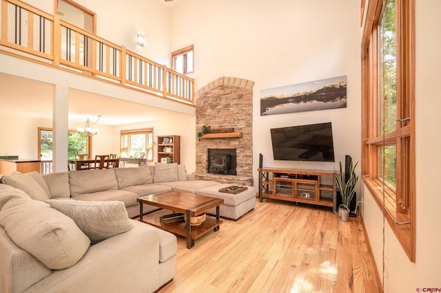 95 Ute Pass W, Durango, CO 81301 - living area with a high ceiling, light wood-style flooring, plenty of natural light, a chandelier, and a wood stove