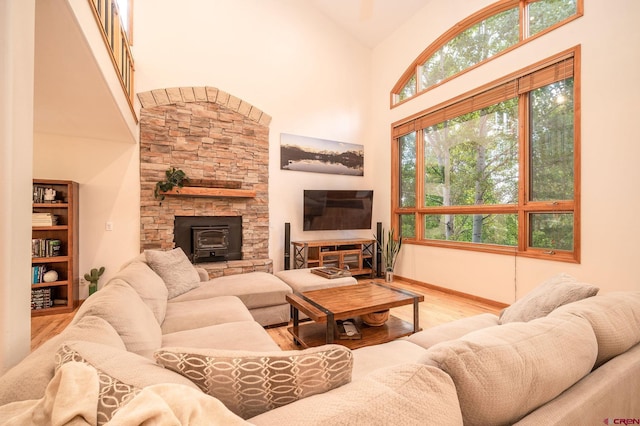 95 Ute Pass W, Durango, CO 81301 - living area featuring wood finished floors, high vaulted ceiling, and a wood stove