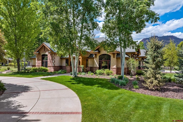435 Red Rock Rd, Durango, CO 81301 - obstructed view of property with stone siding, stucco siding, a front lawn, and a mountain view