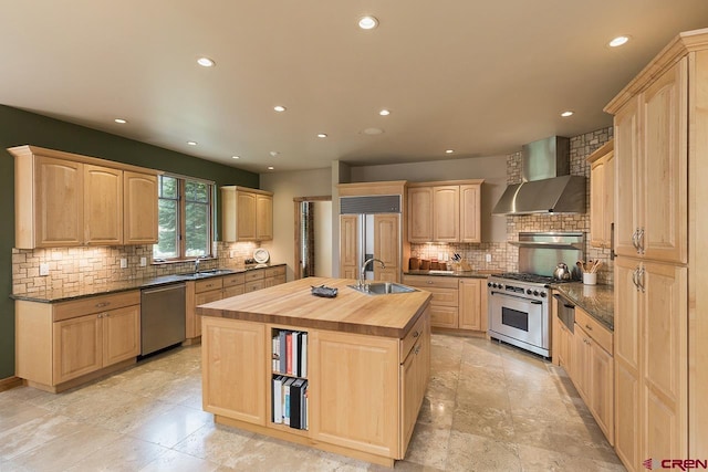 435 Red Rock Rd, Durango, CO 81301 - kitchen with light brown cabinets, premium appliances, wall chimney range hood, butcher block counters, and tasteful backsplash