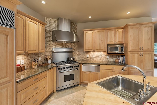 435 Red Rock Rd, Durango, CO 81301 - kitchen with wall chimney range hood, built in appliances, light brown cabinetry, backsplash, and recessed lighting