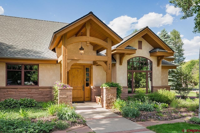 435 Red Rock Rd, Durango, CO 81301 - entrance to property featuring stucco siding, a shingled roof, and stone siding