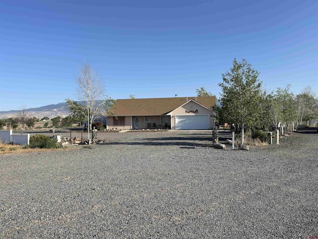 20465 Iris Rd, Austin, CO 81410 - view of front of house featuring a garage and a mountain view