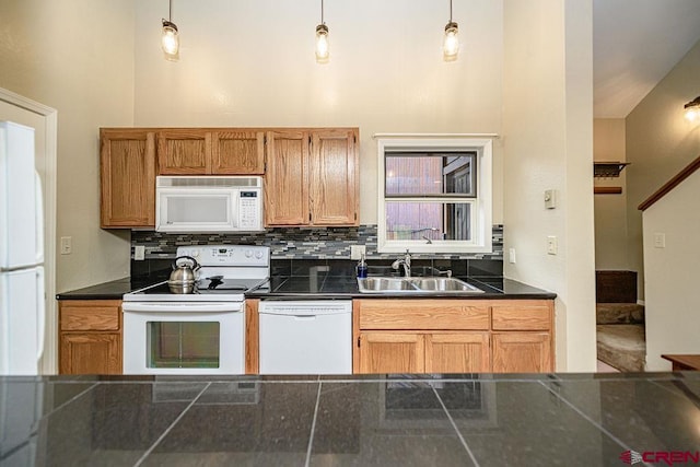 166 Yankee Girl Ct Unit 313, Durango, CO 81301 - kitchen featuring white appliances, dark countertops, tasteful backsplash, and hanging light fixtures