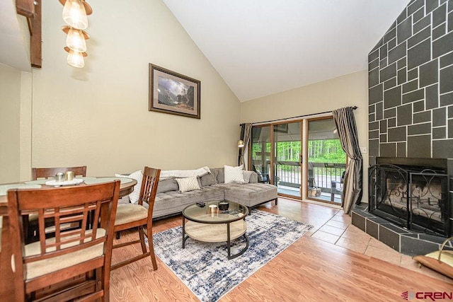166 Yankee Girl Ct Unit 313, Durango, CO 81301 - living room featuring a tiled fireplace, high vaulted ceiling, and wood finished floors