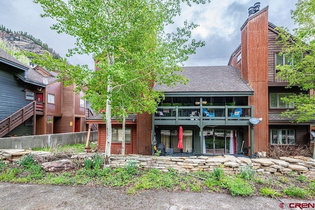 166 Yankee Girl Ct Unit 313, Durango, CO 81301 - back of house with a chimney, roof with shingles, and a balcony