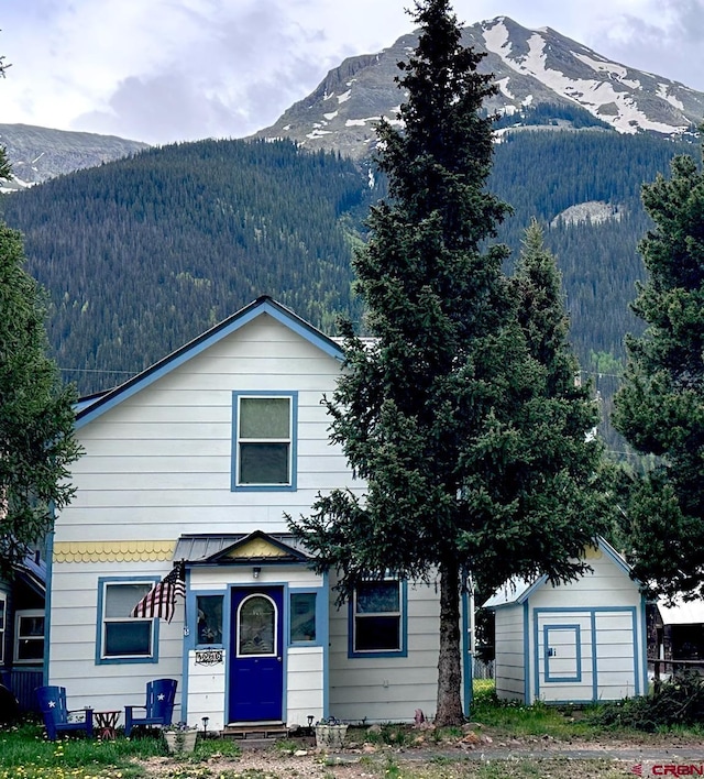 1250 Snowden St, Silverton, CO 81433 - view of front of property featuring a mountain view, a storage unit, and a wooded view