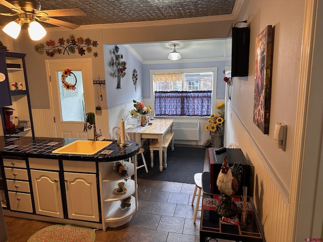 1250 Snowden St, Silverton, CO 81433 - kitchen with tile counters, open shelves, ornamental molding, ceiling fan, and a wainscoted wall