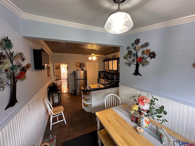 1250 Snowden St, Silverton, CO 81433 - dining area with crown molding, wainscoting, and dark tile patterned flooring