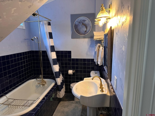 1250 Snowden St, Silverton, CO 81433 - full bath with tile walls, tiled shower / bath combo, wainscoting, and tile patterned floors