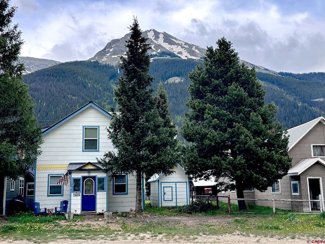 1250 Snowden St, Silverton, CO 81433 - view of front facade with a mountain view, a shed, and a forest view