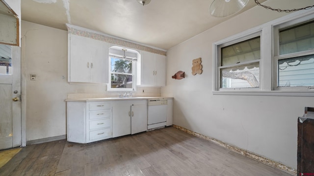735 Teller Ave, Grand Junction, CO 81501 - kitchen featuring dishwasher, light countertops, white cabinets, and wood finished floors
