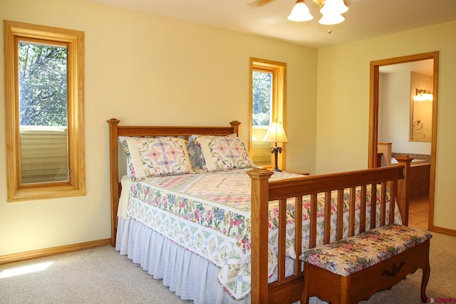 67 Gleneagles Dr, Durango, CO 81301 - carpeted bedroom with multiple windows, ensuite bath, and a ceiling fan