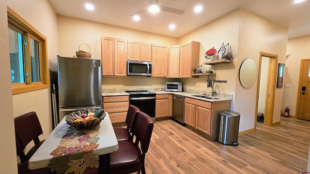 67 Gleneagles Dr, Durango, CO 81301 - kitchen with appliances with stainless steel finishes, light brown cabinetry, light wood finished floors, a ceiling fan, and recessed lighting
