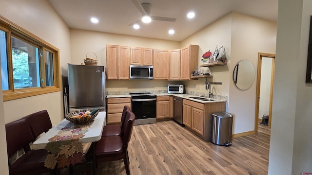67 Gleneagles Dr, Durango, CO 81301 - kitchen with appliances with stainless steel finishes, light brown cabinetry, light wood finished floors, a ceiling fan, and recessed lighting