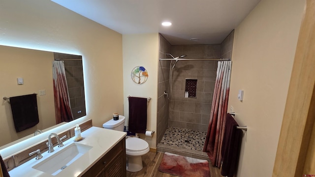 67 Gleneagles Dr, Durango, CO 81301 - full bath with vanity, a tile shower, wood finished floors, and recessed lighting