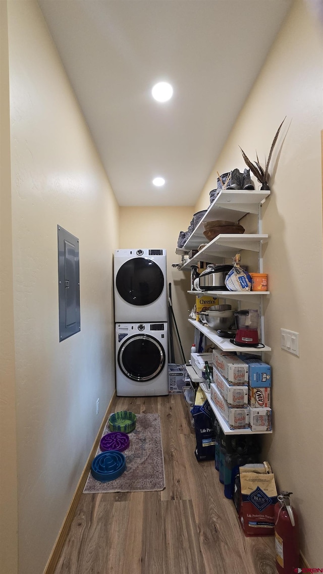 67 Gleneagles Dr, Durango, CO 81301 - laundry room with stacked washer / dryer, electric panel, wood finished floors, and recessed lighting