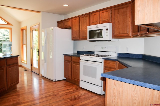 67 Gleneagles Dr, Durango, CO 81301 - kitchen with white appliances, dark countertops, brown cabinets, and recessed lighting