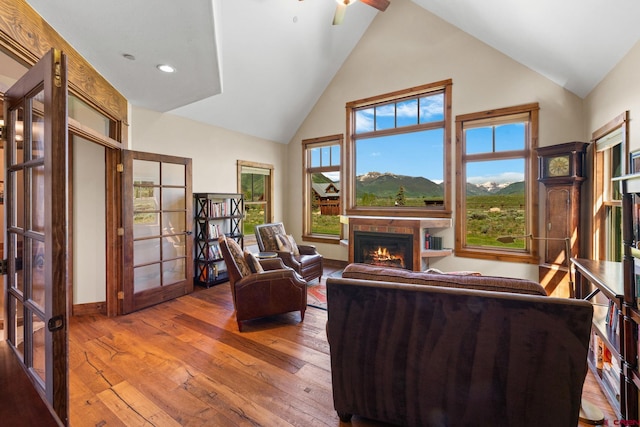 322 Wapiti Ln, Crested Butte, CO 81224 - living area featuring a glass covered fireplace, high vaulted ceiling, hardwood / wood-style floors, french doors, and ceiling fan