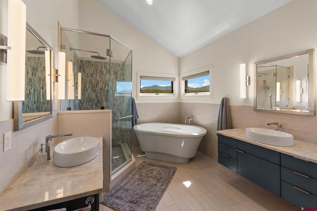 322 Wapiti Ln, Crested Butte, CO 81224 - bathroom featuring tile walls, a shower stall, lofted ceiling, vanity, and a soaking tub