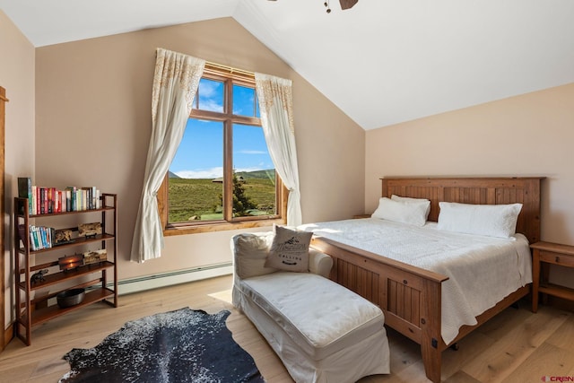 322 Wapiti Ln, Crested Butte, CO 81224 - bedroom featuring a baseboard radiator, vaulted ceiling, and light wood-style floors