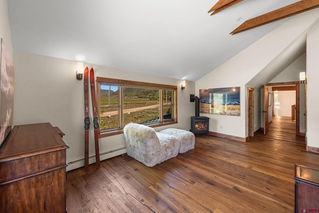 322 Wapiti Ln, Crested Butte, CO 81224 - living area featuring baseboard heating, a wood stove, hardwood / wood-style flooring, and vaulted ceiling